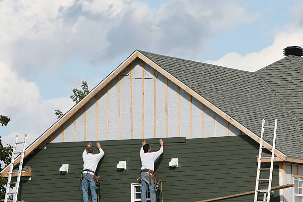 Professional Storm Damage Siding Repair technician working in Adrian, PA